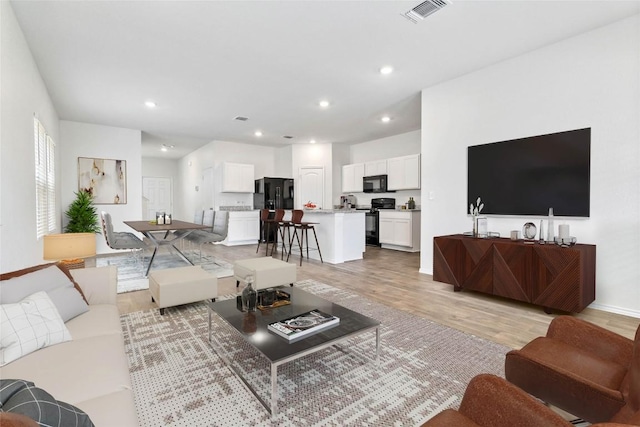 living room with light hardwood / wood-style floors