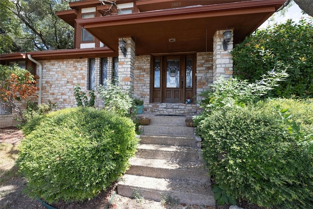 view of exterior entry with covered porch