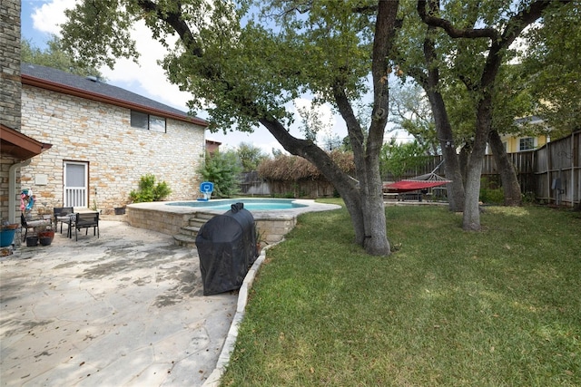 view of yard with a trampoline, a patio, and a fenced in pool