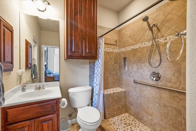 bathroom featuring toilet, vanity, and a shower with shower curtain