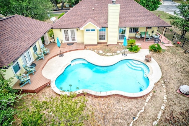 view of swimming pool featuring a patio and a wooden deck