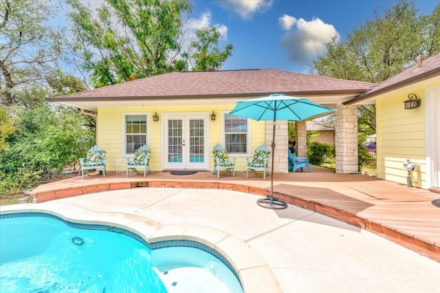 view of swimming pool with a wooden deck and a patio area