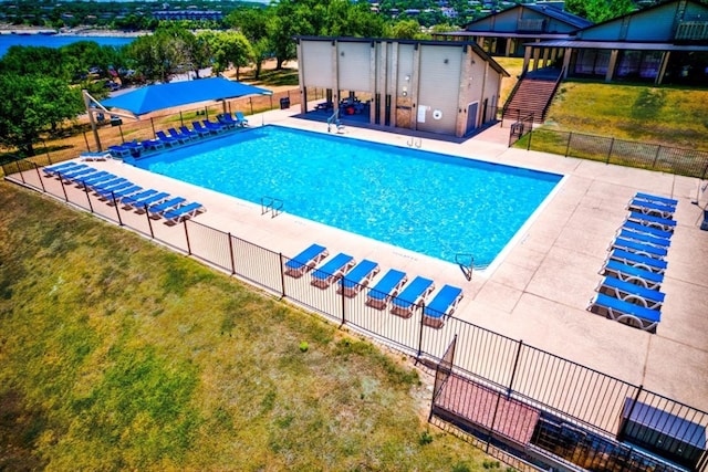 view of swimming pool with a lawn and a patio area