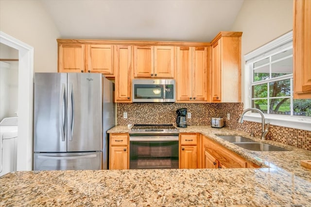 kitchen featuring stainless steel appliances, backsplash, sink, and lofted ceiling