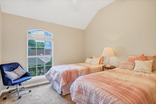 carpeted bedroom featuring vaulted ceiling and multiple windows