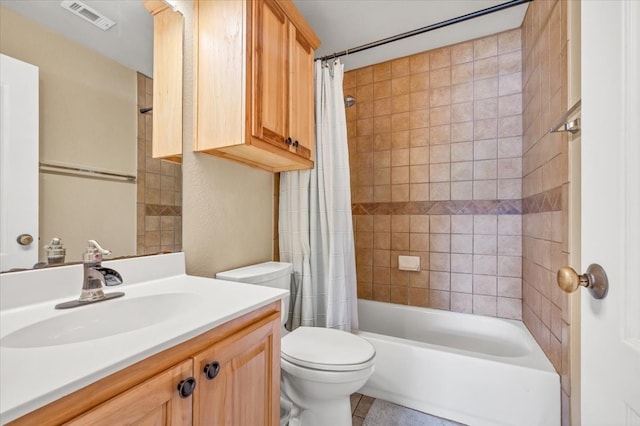 full bathroom with tile patterned flooring, vanity, toilet, and shower / bath combo with shower curtain