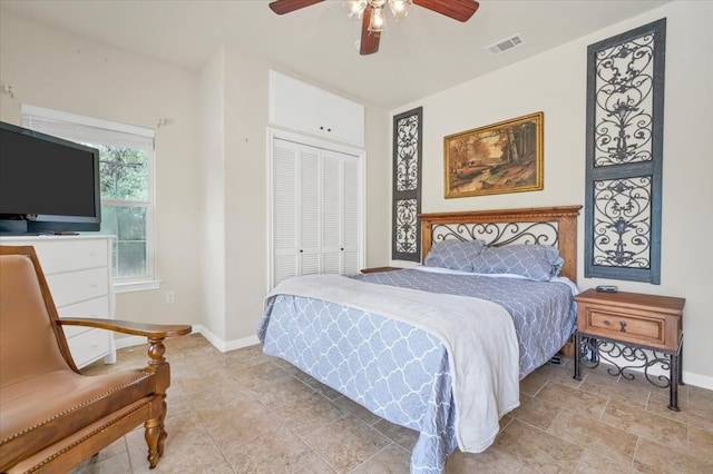 bedroom with ceiling fan and a closet