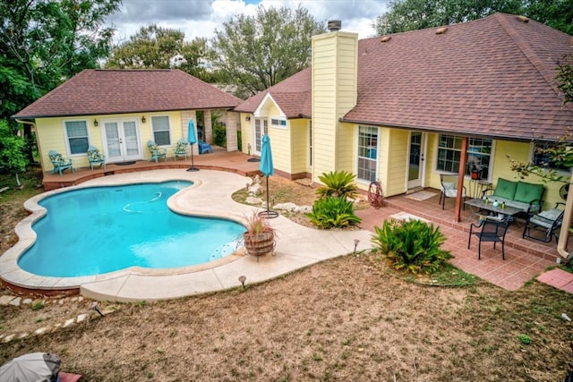 view of pool featuring french doors and a patio