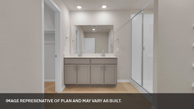 bathroom with vanity, hardwood / wood-style floors, and an enclosed shower