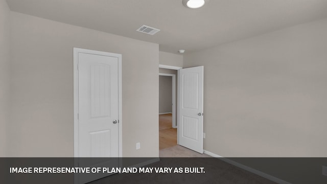 unfurnished bedroom featuring light colored carpet