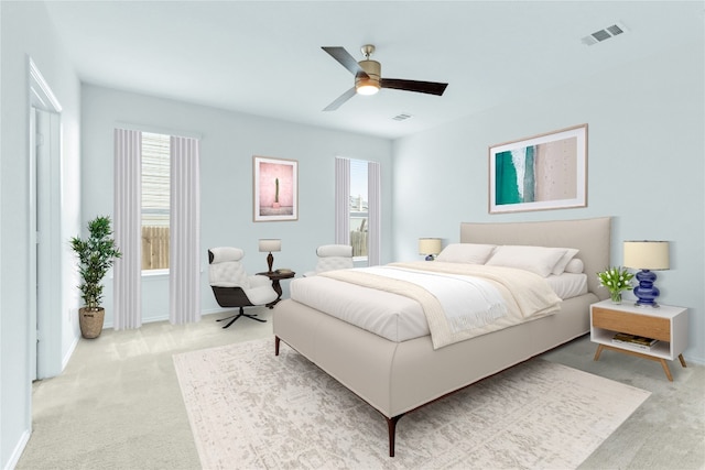 carpeted bedroom featuring multiple windows and ceiling fan