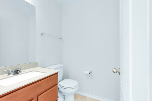 bathroom featuring tile patterned flooring, vanity, and toilet