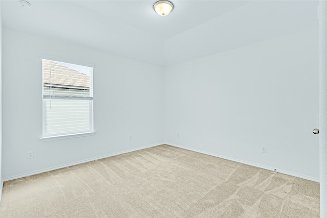 unfurnished room featuring light carpet