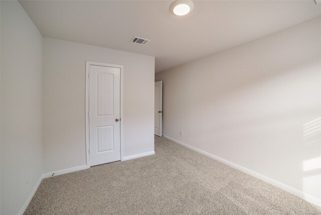 unfurnished room with light carpet