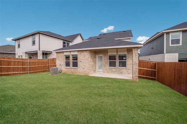 back of house featuring a lawn, central AC, and a patio area