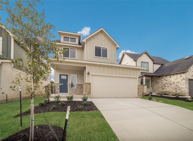 view of front of property with a front yard and a garage