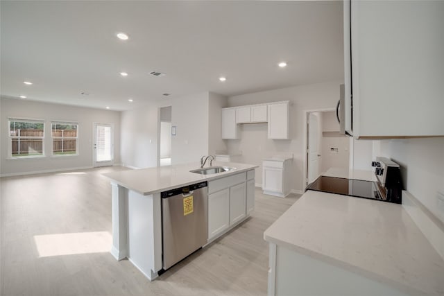 kitchen featuring stainless steel dishwasher, light hardwood / wood-style floors, black range, a kitchen island with sink, and white cabinets