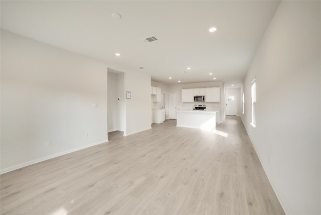 unfurnished living room with light wood-type flooring