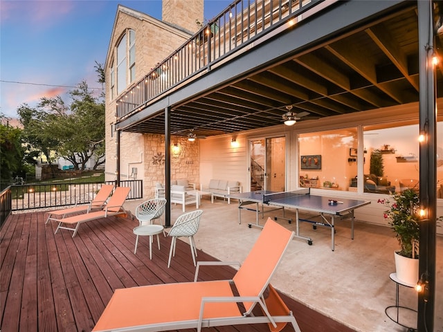 deck at dusk with outdoor lounge area