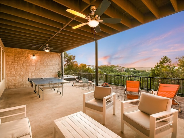 patio terrace at dusk with ceiling fan and an outdoor hangout area