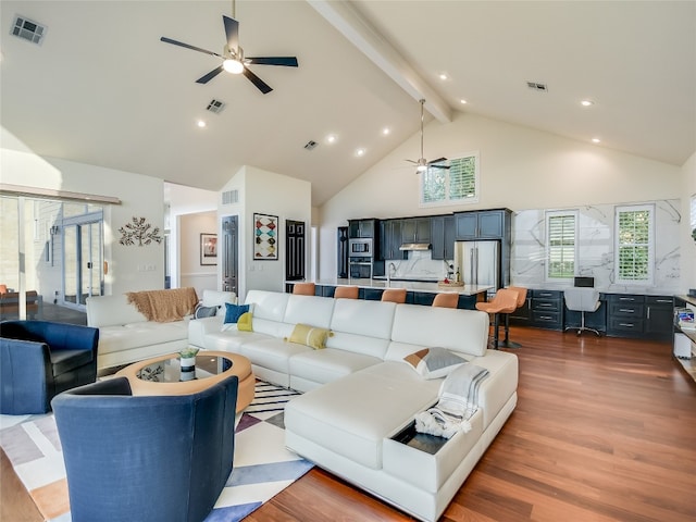 living room featuring wood-type flooring, beamed ceiling, and ceiling fan