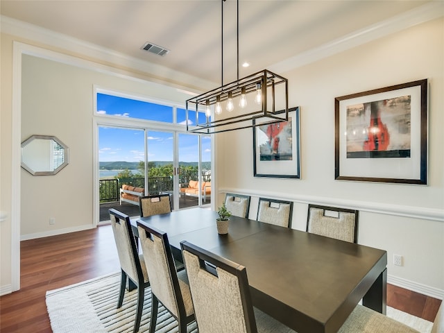 dining area with an inviting chandelier and dark hardwood / wood-style floors