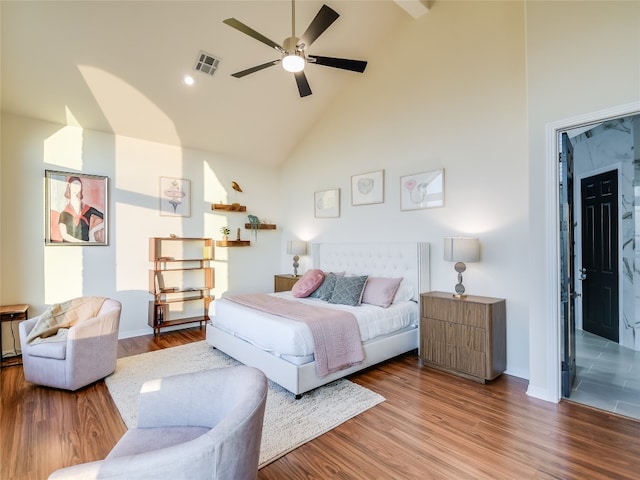 bedroom with high vaulted ceiling, ceiling fan, and hardwood / wood-style floors