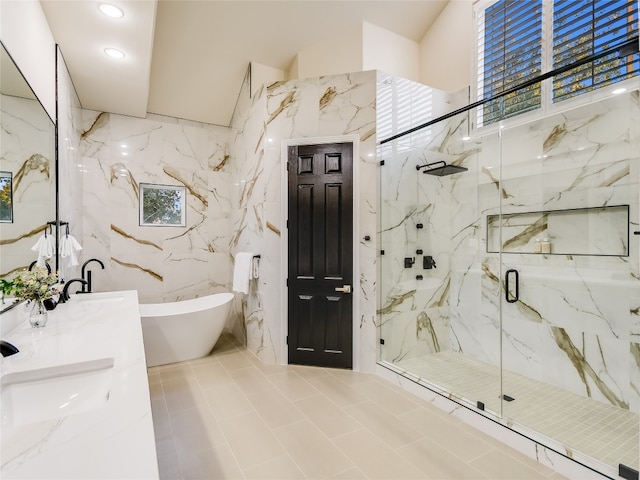 bathroom featuring independent shower and bath, tile walls, vanity, and tile patterned floors