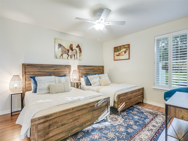 bedroom with hardwood / wood-style floors and ceiling fan