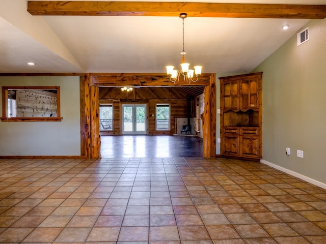 unfurnished room with vaulted ceiling with beams, wooden walls, ceiling fan with notable chandelier, and light tile patterned floors