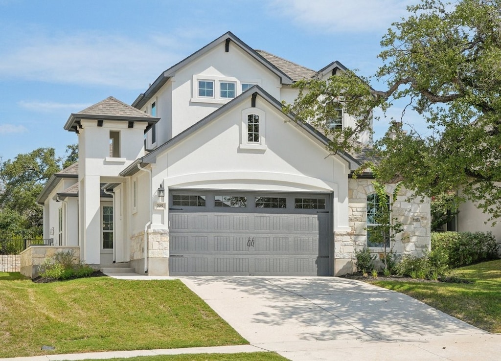 view of front of property with a front yard and a garage