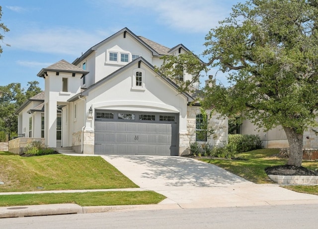 view of front of property featuring a front yard and a garage