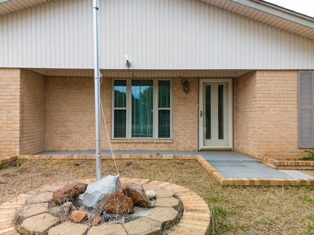 view of exterior entry featuring a patio