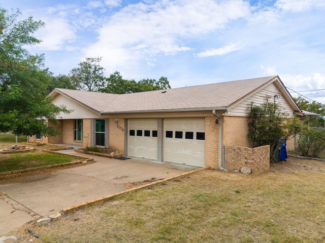 single story home featuring a front lawn and a garage