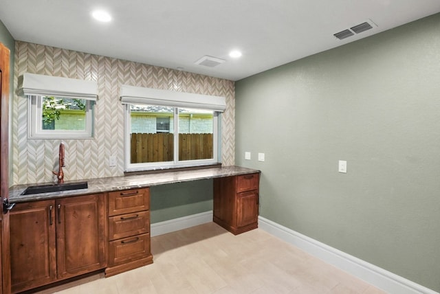 office space with visible vents, a sink, built in desk, recessed lighting, and baseboards