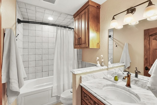 bathroom with vanity, shower / bathtub combination with curtain, visible vents, toilet, and a textured wall