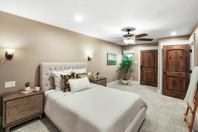 carpeted bedroom with a ceiling fan and baseboards