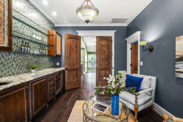 kitchen with dark wood finished floors, tasteful backsplash, light stone countertops, and visible vents