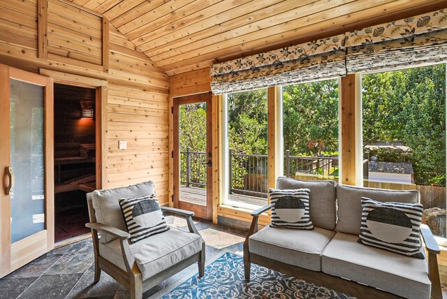 sunroom featuring lofted ceiling and wood ceiling