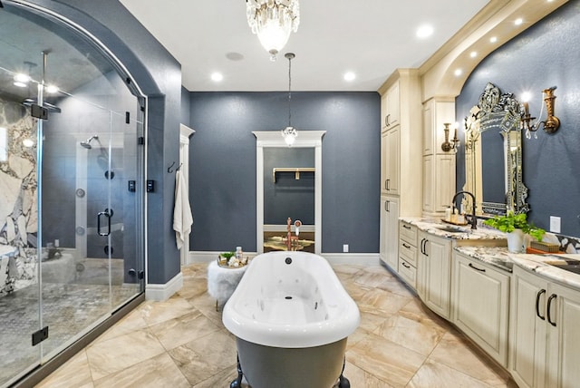 bathroom featuring baseboards, double vanity, a freestanding tub, a stall shower, and marble finish floor