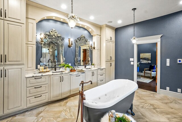 full bathroom featuring vanity, recessed lighting, baseboards, and a freestanding bath