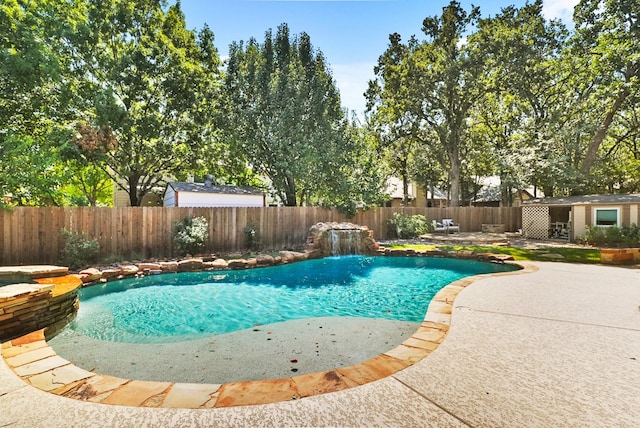 view of pool featuring a fenced in pool, a patio, an outbuilding, and a fenced backyard