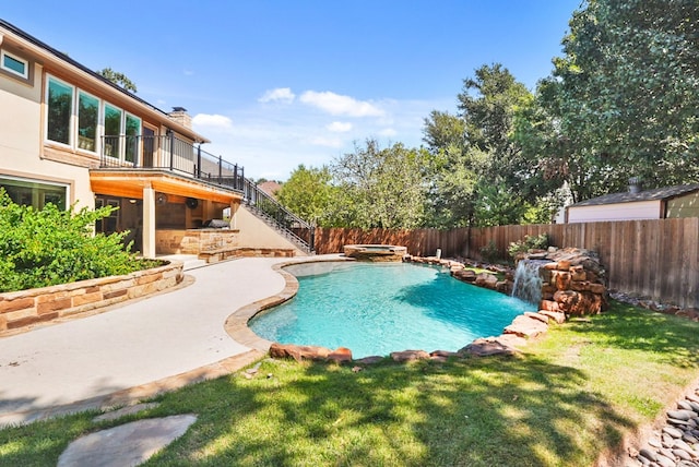 view of swimming pool with a pool with connected hot tub, stairs, a lawn, a fenced backyard, and a patio area