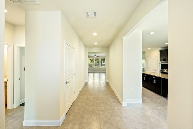 hall featuring light tile patterned floors