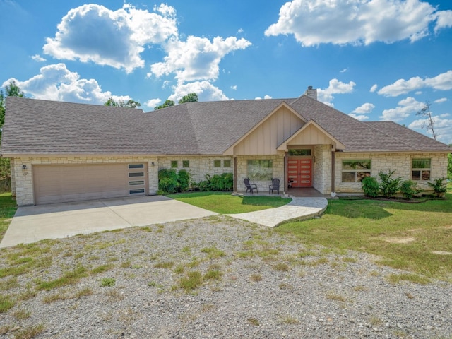 view of front of property with a front lawn and a garage