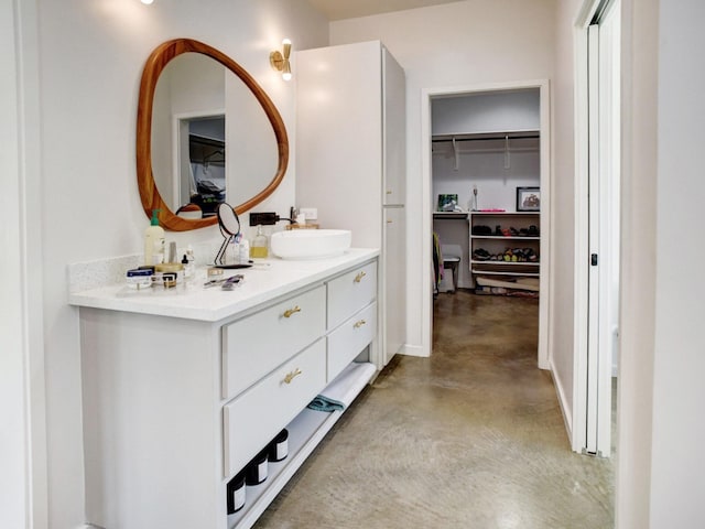 bathroom featuring concrete flooring and vanity