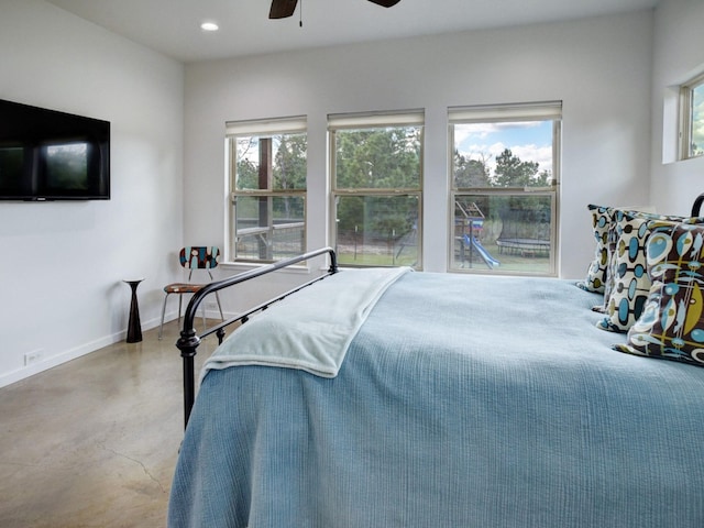 bedroom with multiple windows and ceiling fan