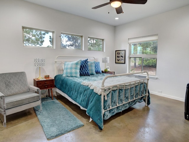 bedroom featuring ceiling fan and concrete floors