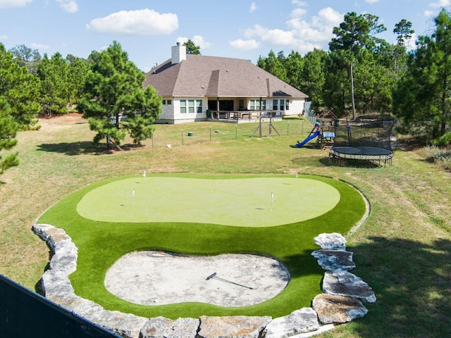 exterior space featuring a playground and a yard