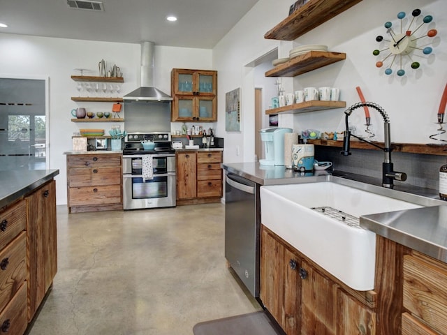 kitchen with sink, wall chimney range hood, and stainless steel appliances